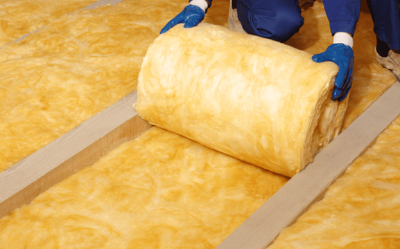 Glass wool insulation material being handled