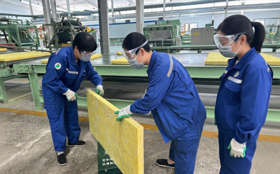Glass wool insulation material being handled